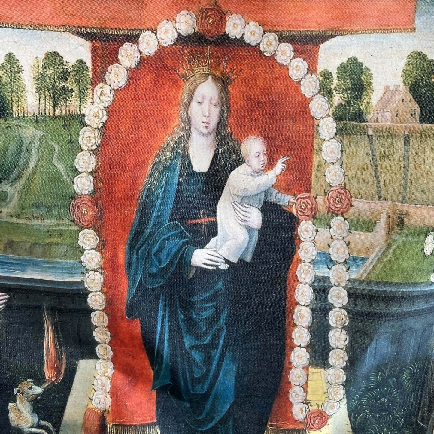 Close-up of the central panel showing the Virgin Mary and Christ Child framed by a detailed border of roses — design detail from the altarpiece.