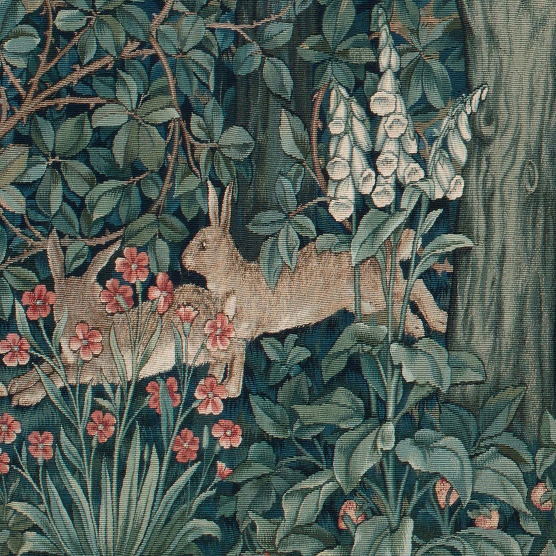 Detail of rabbits running near a tree trunk with white foxglove flowers from the William Morris Greenery dark forest tapestry.