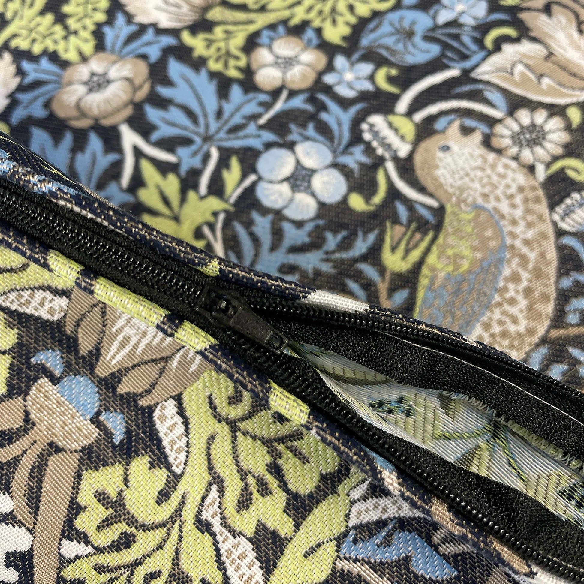 Open zipper detail on the William Morris Strawberry Thief jacquard pillow cover.