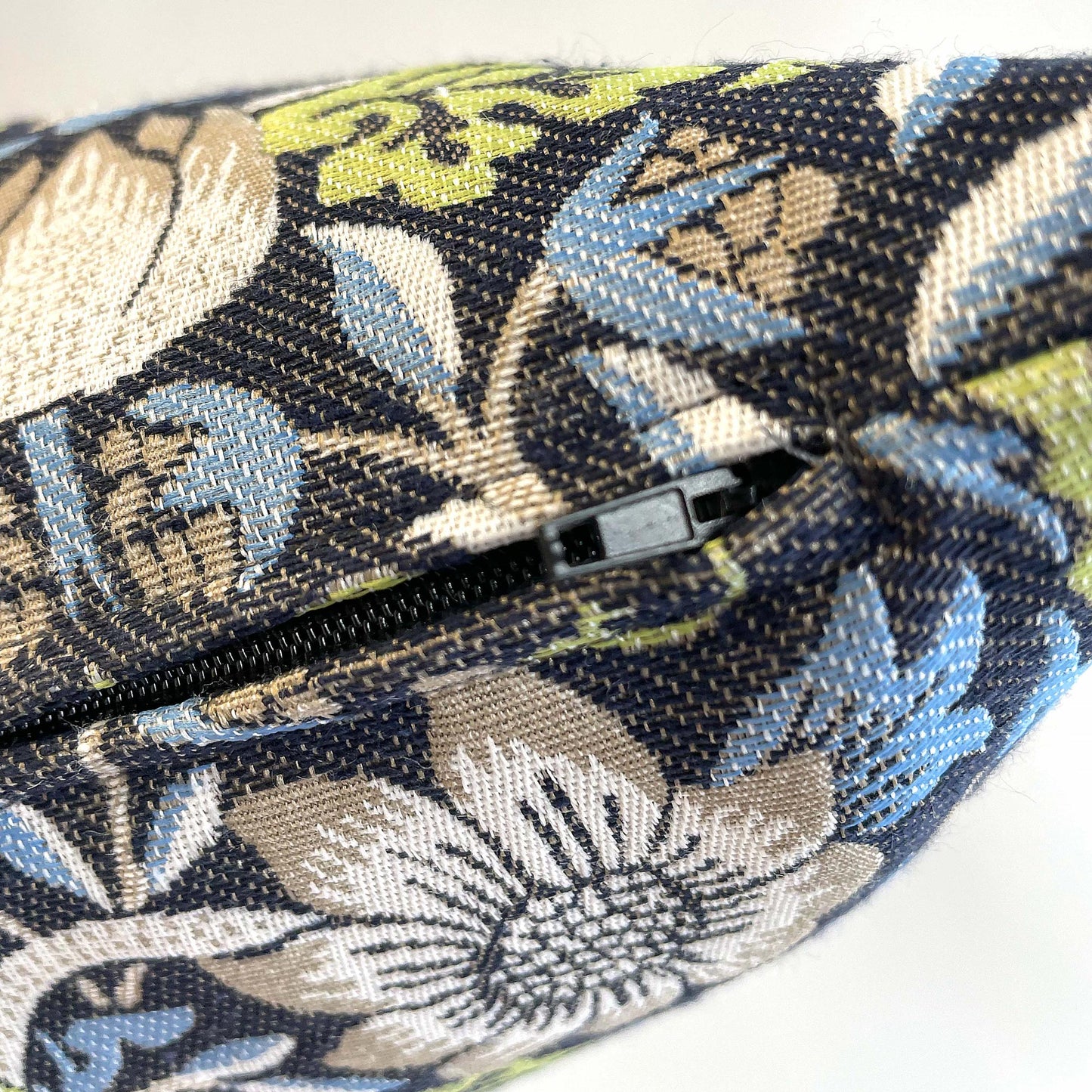 Zipper slider and side seam on the William Morris Strawberry Thief jacquard pillow cover.