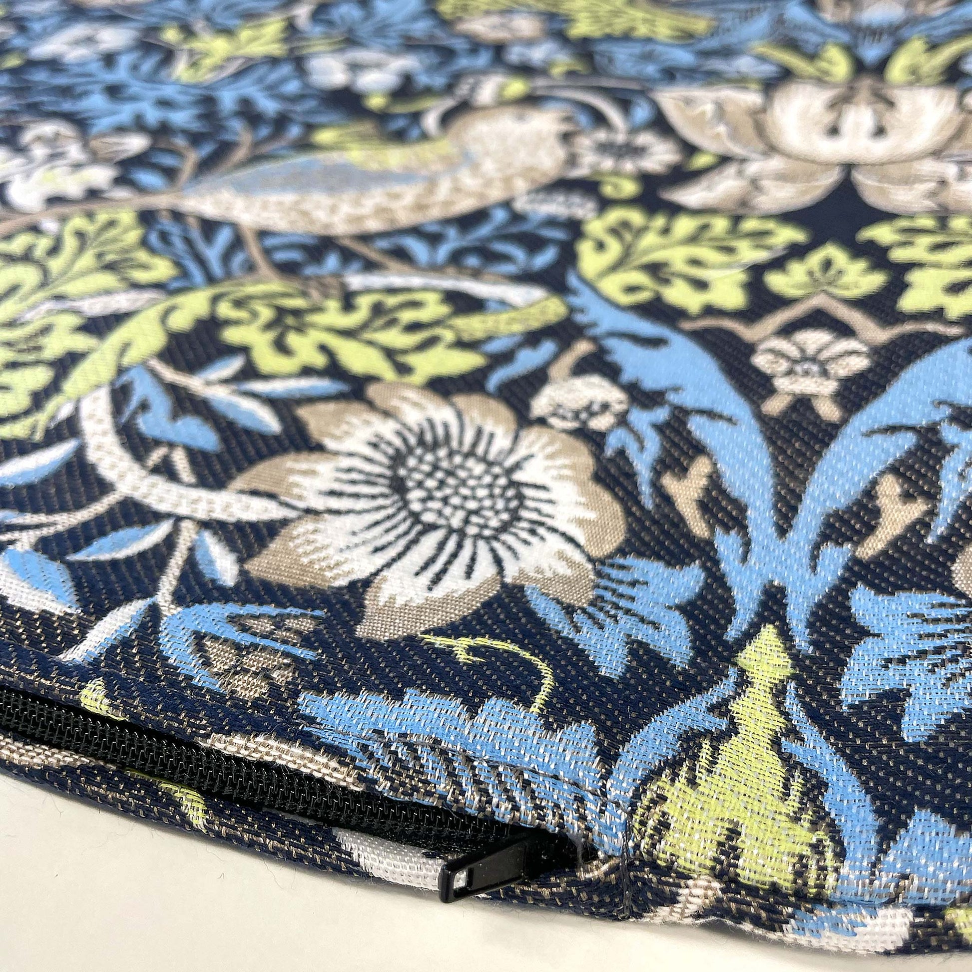 Bottom edge of the William Morris Strawberry Thief jacquard pillow cover showing the concealed zipper.